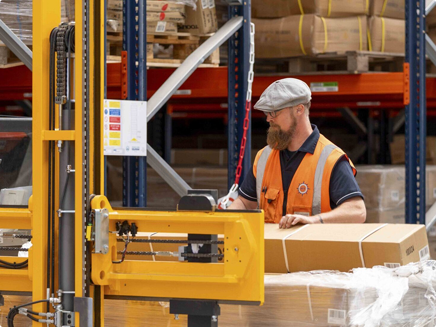 Man driving forklift in a warehouse